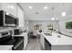 Open-concept kitchen with an island overlooking the dining and living areas at 385 Cape Honeysuckle Pl, Sanford, FL 32771