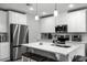 Modern kitchen featuring white cabinets, stainless steel appliances, and an island with bar stool seating at 385 Cape Honeysuckle Pl, Sanford, FL 32771