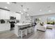 Modern kitchen with a center island, breakfast bar seating, and stainless steel appliances at 385 Cape Honeysuckle Pl, Sanford, FL 32771