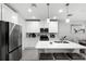 Bright kitchen features an island with bar seating and stainless steel appliances at 385 Cape Honeysuckle Pl, Sanford, FL 32771