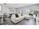 Bright living room featuring a white couch and tiled floors at 385 Cape Honeysuckle Pl, Sanford, FL 32771