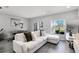 Bright living room featuring a white sectional sofa and sliding glass doors to the outside at 385 Cape Honeysuckle Pl, Sanford, FL 32771