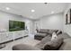Open-concept living space with a large TV and stylish furniture at 385 Cape Honeysuckle Pl, Sanford, FL 32771
