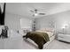 Comfortable main bedroom with a white bed frame and cozy decor at 385 Cape Honeysuckle Pl, Sanford, FL 32771