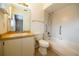 Bright bathroom features a tiled shower-tub combo, vanity, and convenient grab bars for accessibility at 385 Eron Way # 45, Winter Garden, FL 34787