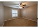 Bedroom featuring cozy carpet, ceiling fan and modern window shutters at 385 Eron Way # 45, Winter Garden, FL 34787