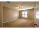 Neutral bedroom offers a ceiling fan, carpet, and a window with modern shutters for comfortable living at 385 Eron Way # 45, Winter Garden, FL 34787