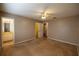 Cozy bedroom with ceiling fan and carpeted floors, adjoined by a clean bathroom and a walk-in closet at 385 Eron Way # 45, Winter Garden, FL 34787