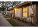 Charming exterior of a single-story home with neutral stucco, brown trim, shutters, and manicured landscaping at 385 Eron Way # 45, Winter Garden, FL 34787
