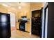 Kitchen featuring stove, microwave, black refrigerator, and laundry area with stacked washer and dryer at 385 Eron Way # 45, Winter Garden, FL 34787