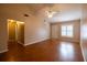 Cozy living room featuring wood-look floors, vaulted ceiling with ceiling fan, and a bright window at 385 Eron Way # 45, Winter Garden, FL 34787