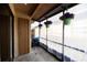 Cozy covered patio area featuring a grill and hanging flower baskets, perfect for outdoor relaxation and entertaining at 385 Eron Way # 45, Winter Garden, FL 34787