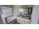 Bathroom with a large soaking tub and double sink vanity at 4151 Forest Island Dr, Orlando, FL 32826