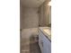 Bathroom featuring gray tile, granite countertop, and white vanity cabinet at 4151 Forest Island Dr, Orlando, FL 32826
