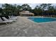 Community pool with lounge chairs and a clubhouse in the background at 4151 Forest Island Dr, Orlando, FL 32826