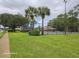 Community tennis courts surrounded by lush landscaping and green lawns at 4151 Forest Island Dr, Orlando, FL 32826