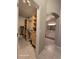 Walk-in closet with wooden shelving adjacent to an ensuite bathroom at 4151 Forest Island Dr, Orlando, FL 32826