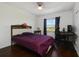 Cozy bedroom with wood floors, gaming setup, and natural light at 4300 Hector Ct # 7, Orlando, FL 32822