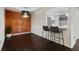 Dining area with dark hardwood floors, a modern light fixture, and adjacent kitchen counter seating at 4300 Hector Ct # 7, Orlando, FL 32822