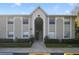 Exterior view of the condo building with well-maintained landscaping and visible unit numbers at 4300 Hector Ct # 7, Orlando, FL 32822
