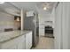 Well-lit kitchen featuring stainless steel appliances, tile flooring, and a view into the dining area at 4300 Hector Ct # 7, Orlando, FL 32822