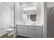 Bright bathroom with double vanity, round mirrors, quartz countertop, and walk-in shower at 4470 Frances Ave, Sanford, FL 32773