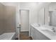 Bright bathroom features double sinks, a tub and shower combination, and wood-look flooring at 4470 Frances Ave, Sanford, FL 32773