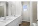 Bright bathroom features double sinks, a tub and shower combination, and wood-look flooring at 4470 Frances Ave, Sanford, FL 32773