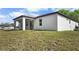 Exterior view of a home with a pristine lawn and an extended covered patio at 4470 Frances Ave, Sanford, FL 32773