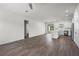 Bright living room showcasing an open floor plan with wood floors and access to the modern kitchen at 4470 Frances Ave, Sanford, FL 32773