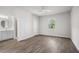 Inviting bedroom with wood-look floors, an ensuite bathroom, and a large window at 4470 Frances Ave, Sanford, FL 32773