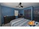 Nicely arranged bedroom with a ceiling fan, desk, drawers, and toys at 5454 San Juan Blvd, Orlando, FL 32807