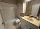 Traditional bathroom features a tub and shower combo, vanity with white cabinetry, and ample lighting at 619 Blenheim Loop, Winter Springs, FL 32708
