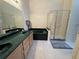 Bathroom featuring dual sinks, a garden tub with dark countertops and a glass enclosed shower at 619 Blenheim Loop, Winter Springs, FL 32708