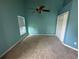 Bright bedroom with light-blue walls, ceiling fan, and a double-door closet for ample storage at 619 Blenheim Loop, Winter Springs, FL 32708