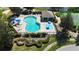 Aerial view of the community pool and splashpad, surrounded by lounge chairs and landscaping at 619 Blenheim Loop, Winter Springs, FL 32708
