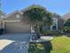 Beautiful home exterior showcasing well-maintained lawn and a two-car garage at 619 Blenheim Loop, Winter Springs, FL 32708