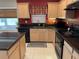 Kitchen showcasing black appliances, granite countertops, maple cabinets, and a modern faucet at 619 Blenheim Loop, Winter Springs, FL 32708
