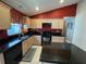 Kitchen featuring black appliances, granite countertops, maple cabinets, and tile backsplash at 619 Blenheim Loop, Winter Springs, FL 32708
