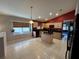 Kitchen boasts tile floors, maple cabinets, granite countertops, and window overlooking yard at 619 Blenheim Loop, Winter Springs, FL 32708