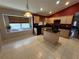 Kitchen with black appliances, granite countertops, tile floors, and window above sink at 619 Blenheim Loop, Winter Springs, FL 32708