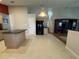 Open kitchen and dining area with tile floors, center island, and black refrigerator at 619 Blenheim Loop, Winter Springs, FL 32708