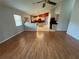 Open-concept living space with hardwood floors flowing into the kitchen and dining area at 619 Blenheim Loop, Winter Springs, FL 32708