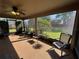 Cozy screened-in patio with ceiling fan and views of the backyard and manicured lawn at 619 Blenheim Loop, Winter Springs, FL 32708