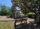 Playground with climbing structure, slide, benches, and green space with trees in a park setting at 619 Blenheim Loop, Winter Springs, FL 32708