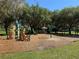 Playground area with swings, climbing structure, gazebo and benches in a park area with grass at 619 Blenheim Loop, Winter Springs, FL 32708