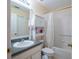 Well-lit bathroom with a combination shower and tub plus an integrated shelving unit for optimized storage at 6367 Merrick Landing Blvd, Windermere, FL 34786