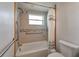 Updated bathroom with tiled shower and tub combo including safety bars and shower head at 651 W Lake Brantley Rd, Altamonte Springs, FL 32714
