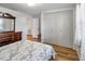 Well-lit bedroom featuring a spacious closet, dresser with mirror, and wood look flooring at 651 W Lake Brantley Rd, Altamonte Springs, FL 32714