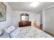 Well-lit bedroom featuring classic decor, wood look flooring, and dresser with mirror at 651 W Lake Brantley Rd, Altamonte Springs, FL 32714